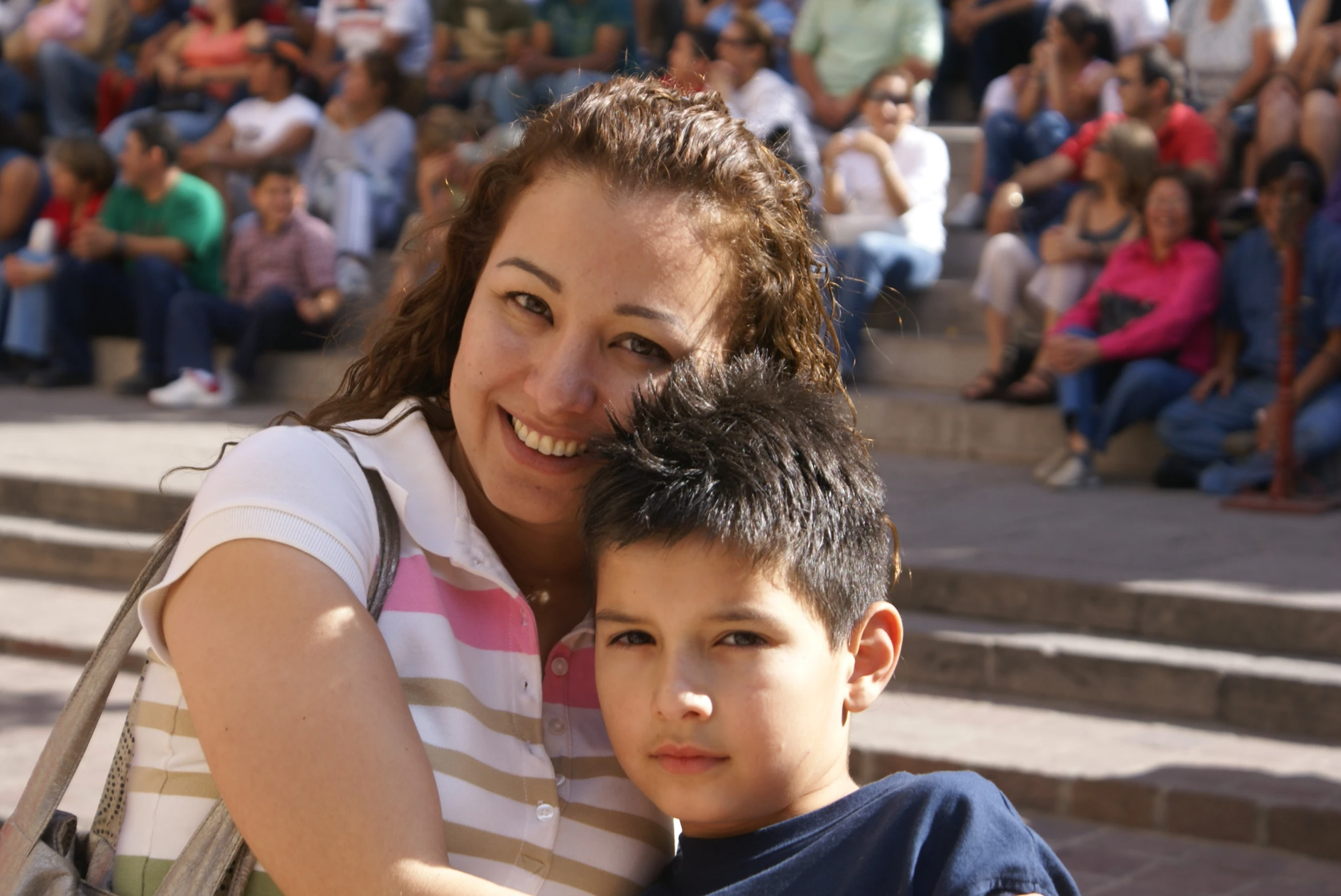 a woman holds a small boy in her arms