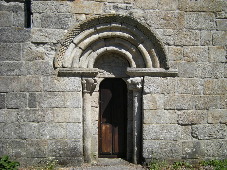 a tall window on the side of a stone building