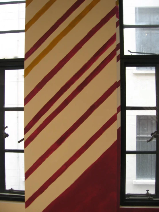 a large red and white striped fabric behind a window