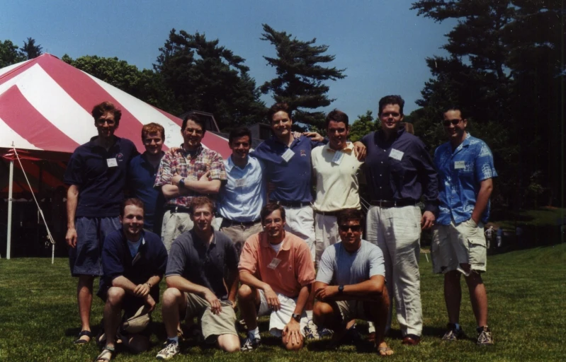 a group of men who are standing in the grass