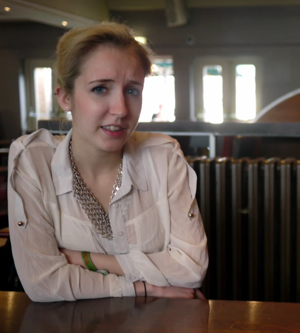 a woman that is sitting down at a table