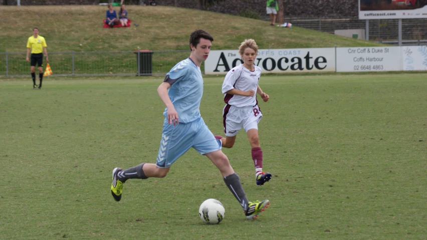 two people are playing soccer on the field