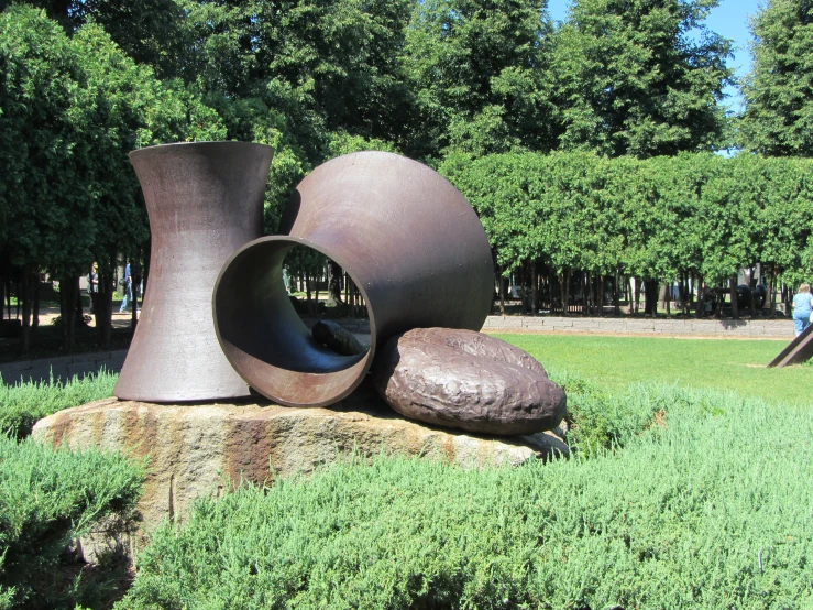 sculptures sitting in a field with many trees