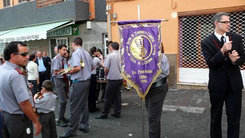 people in the street looking at items displayed for sale