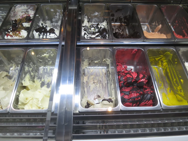 an assortment of ice cream in a display case