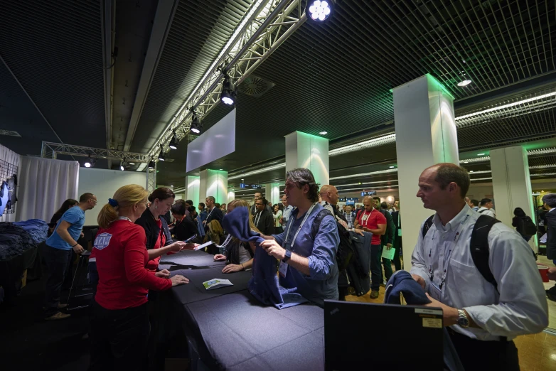 a group of people stand around playing video games