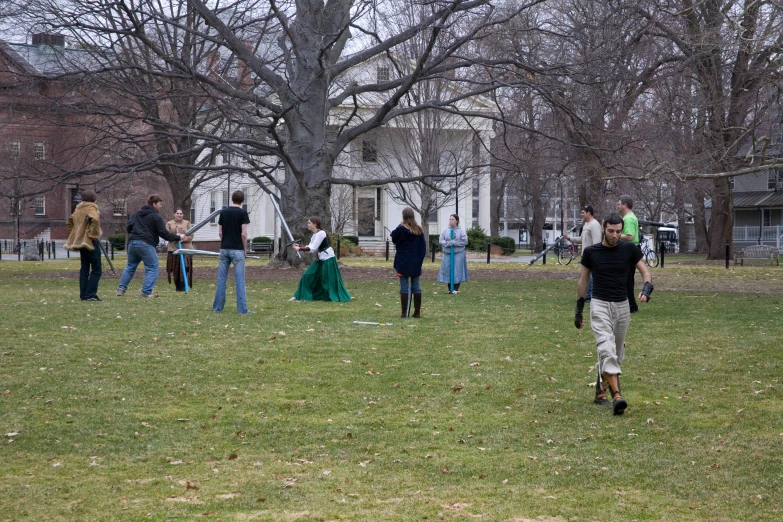 several people play with a frisbee in the grass