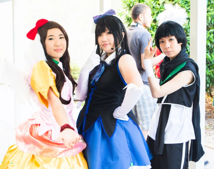 four young people dressed up in costume standing together