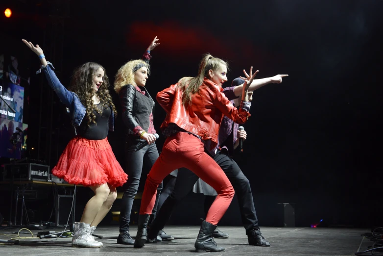 young women performing on stage during a concert