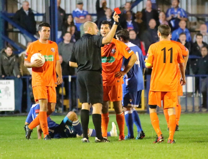 referee giving instructions to his team on the field