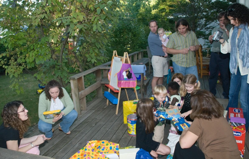 people enjoying their birthday on a porch surrounded by wooded area