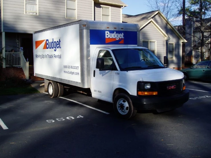 a bulding truck parked in the parking lot of a business