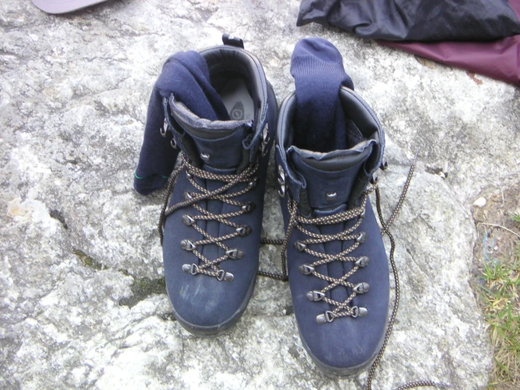 a pair of blue shoes with the heel up on top of them