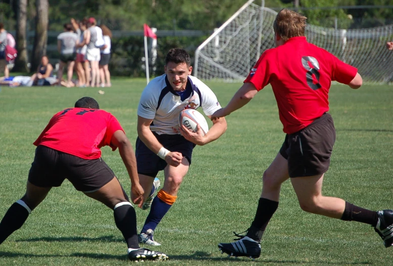 a group of young men play a game of rugby