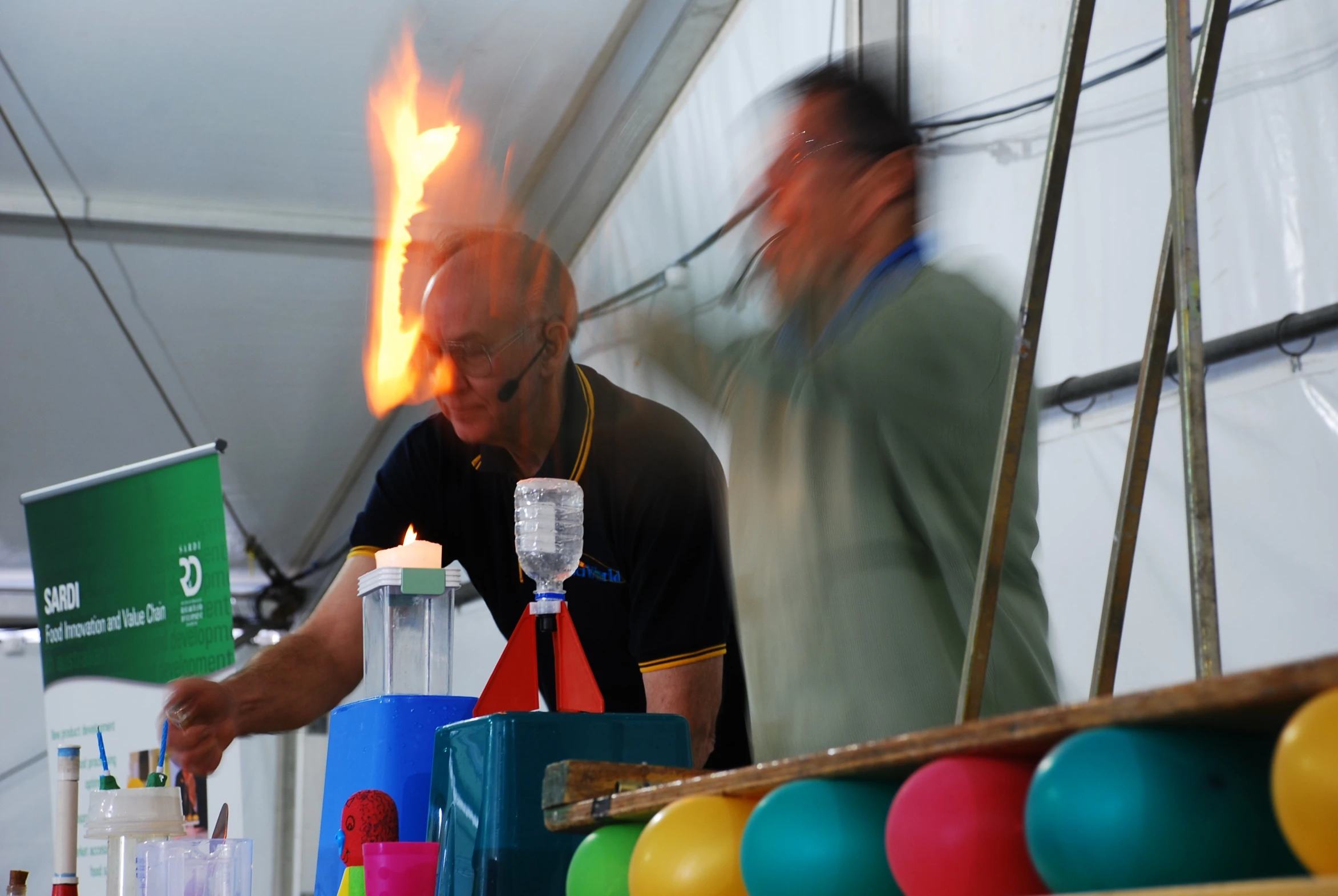 two men are standing near some candles in the air