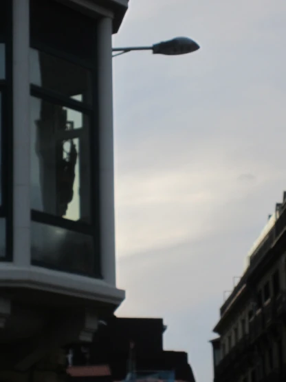 a street light and window in a street with buildings
