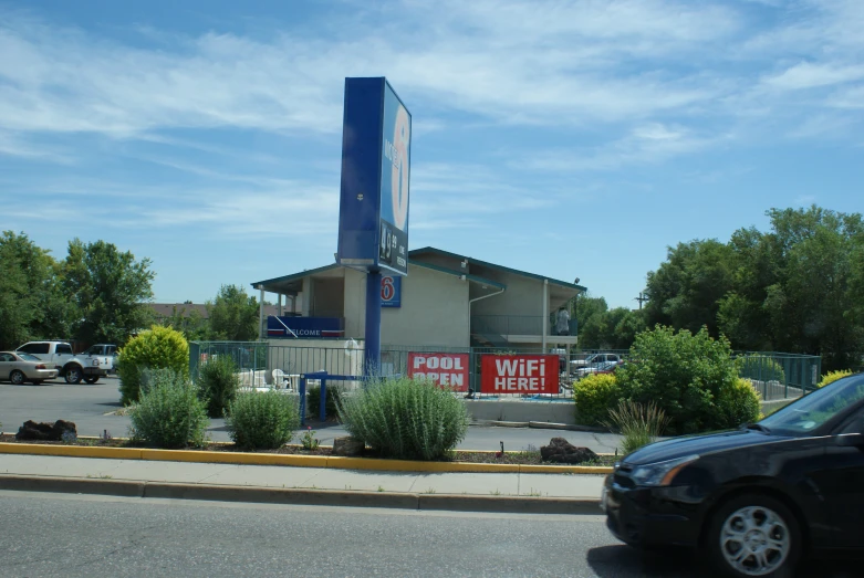 a car parked in front of a motel building