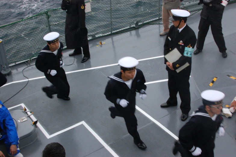 the navy men are dressed in their navy uniforms