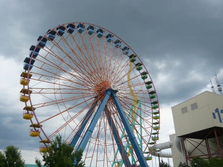 a ferris wheel on a cloudy day with blue skies in the background