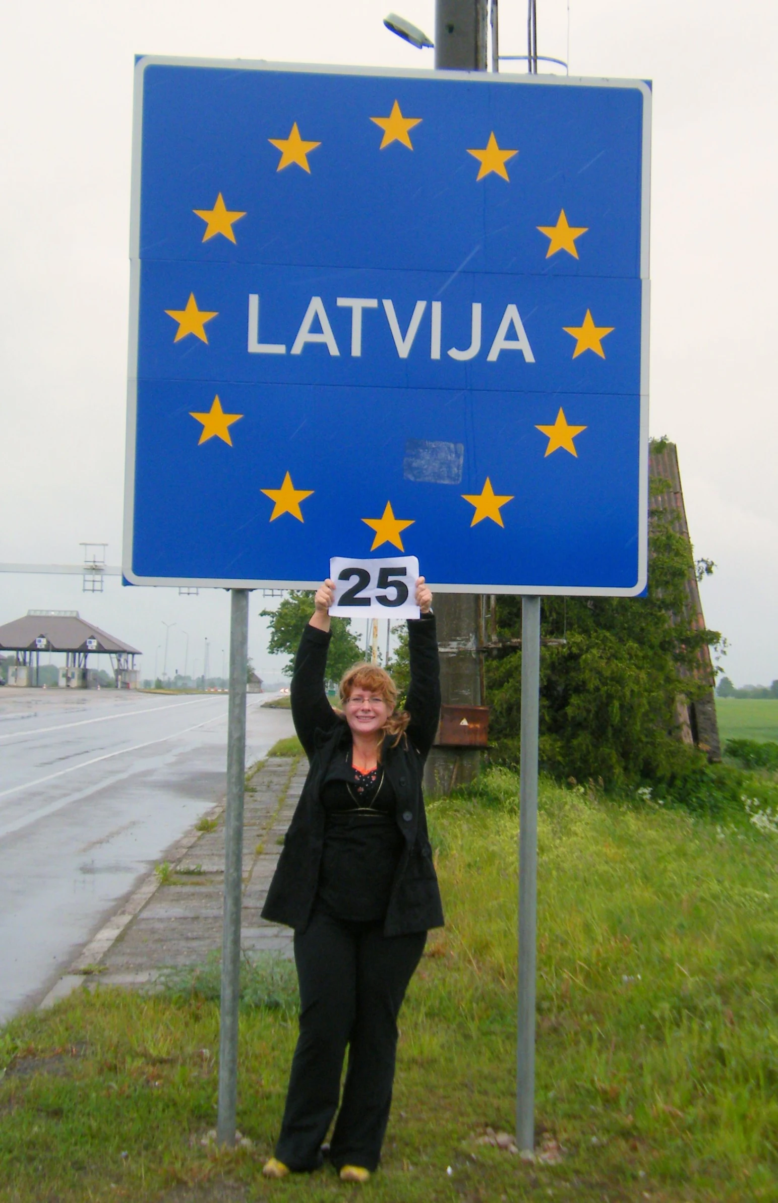 woman in front of street sign showing the date as 15