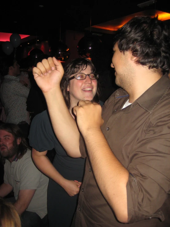 a man and woman dance on a party