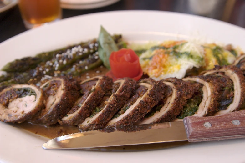 a white plate topped with food and a knife