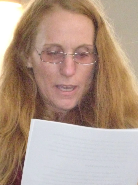 an attractive woman lying on the bed with long red hair