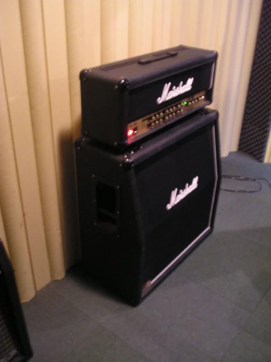 a stack of two black amps sitting on top of each other