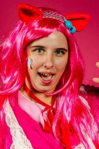 a woman wearing pink wig and blue nose rings