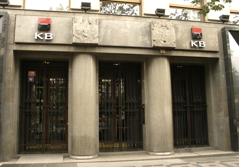 three tall grey buildings with bars in the middle