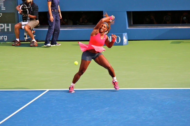 a woman swinging a tennis racquet at a ball