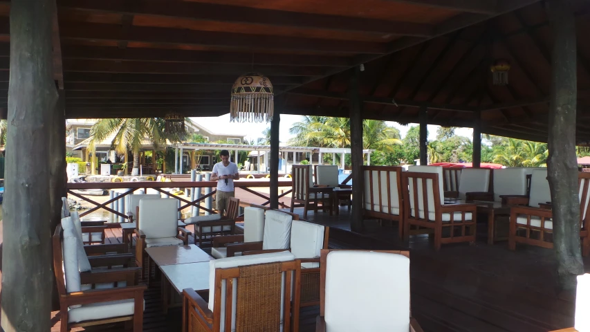 a wooden area with some chairs and tables on it