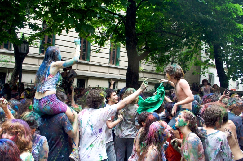a group of people playing in the colored rain