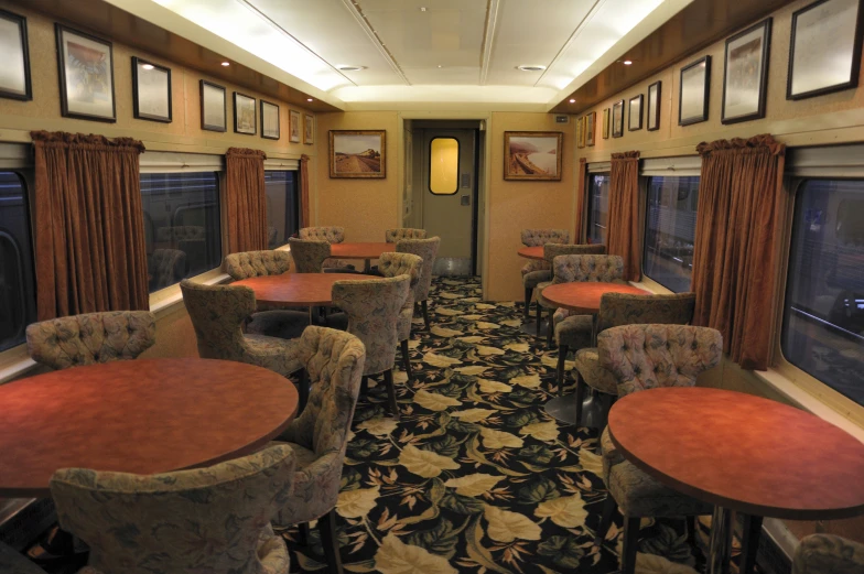 a train car with several seats, and tables