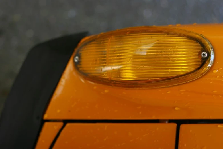 a close - up s of a yellow car's corner