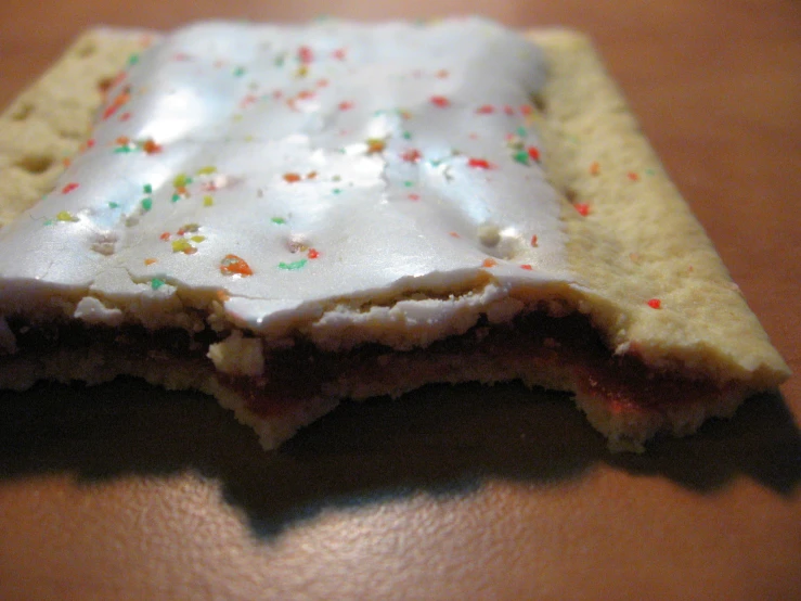 an orange table topped with frosting and sprinkles