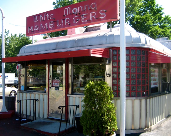 a red and white awning over a white and red diner