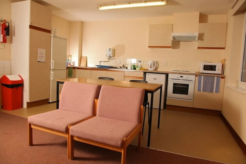 two chairs and a table are in the corner of this kitchen