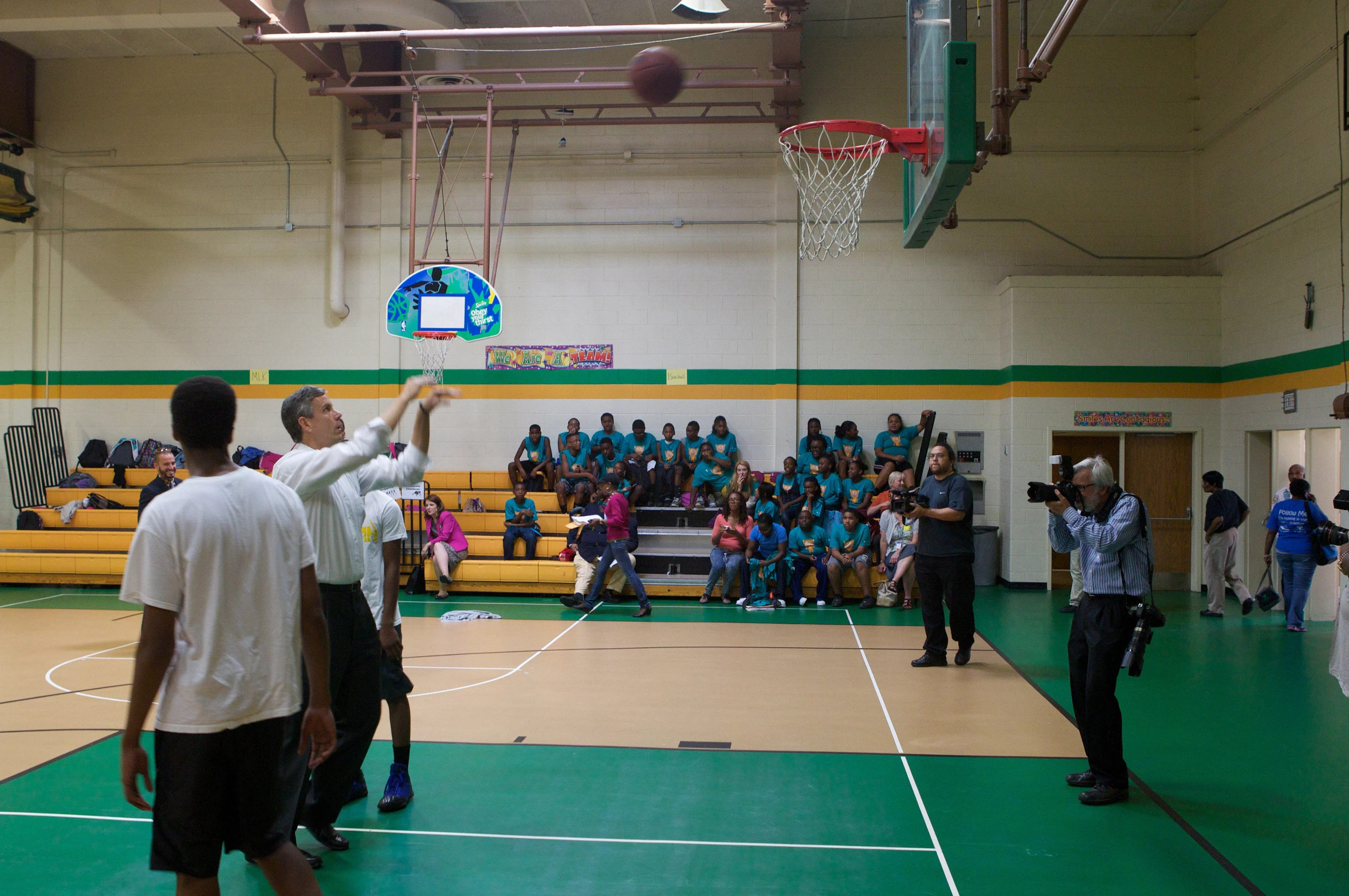 some guys play basketball with people watching