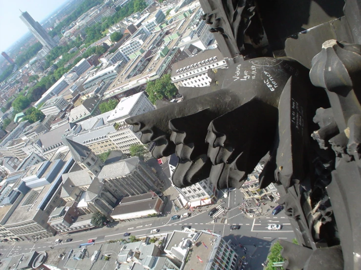 a tall building with lots of buildings and cars in it