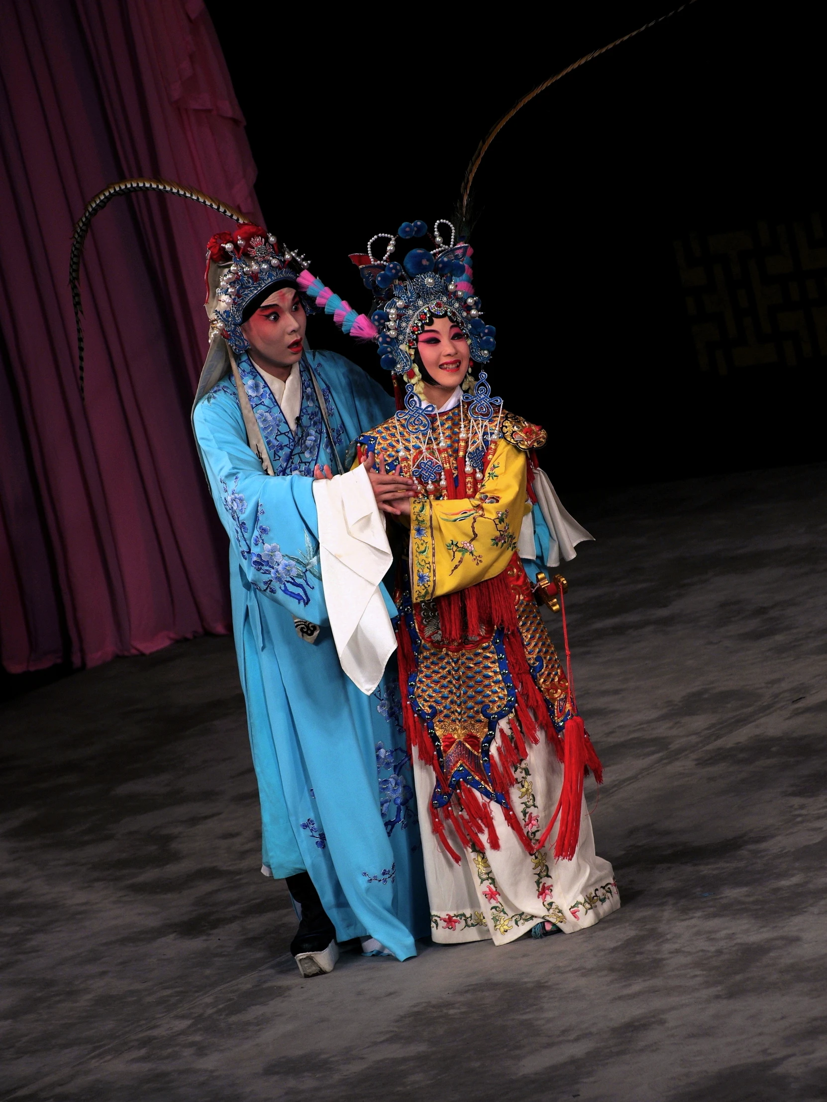 two people in traditional clothing standing beside each other