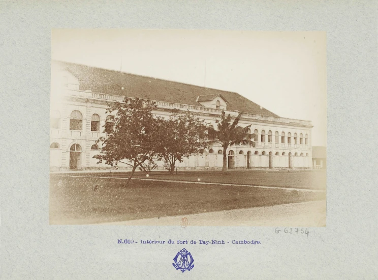 a old po of a building with a tree in front of it