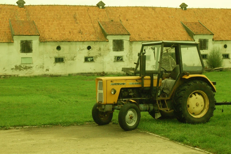 a tractor parked next to a grassy field
