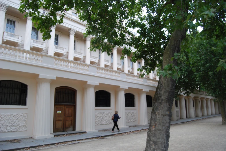 a person walks past the doors of a building