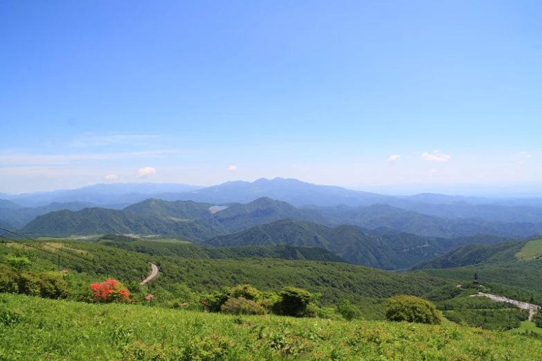 a lush green valley filled with lots of green hills