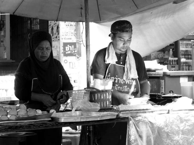 two women in aprons working on some food