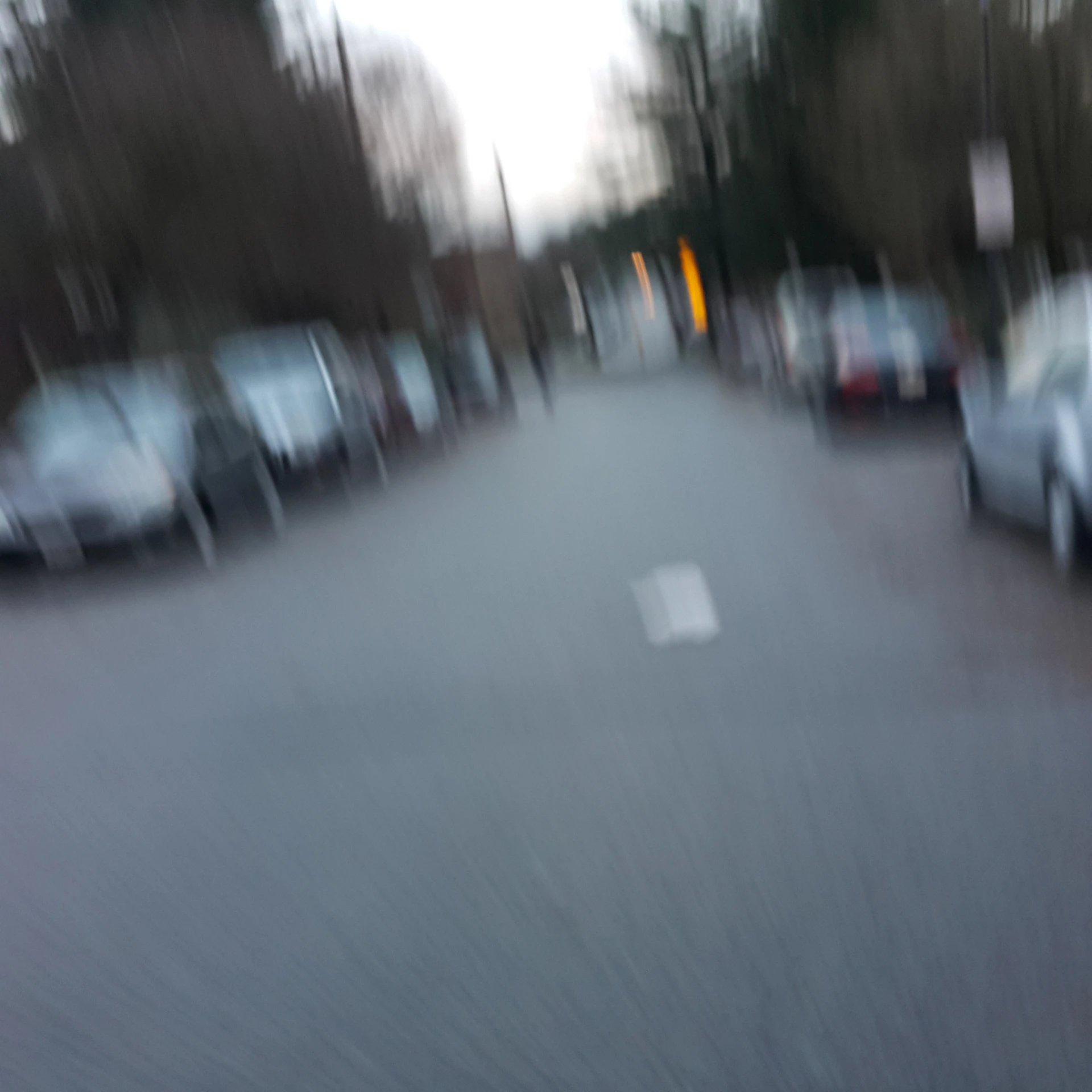 a blurry picture of cars parked next to each other on a street