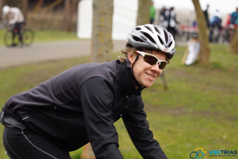 a man riding a bike down a forest road