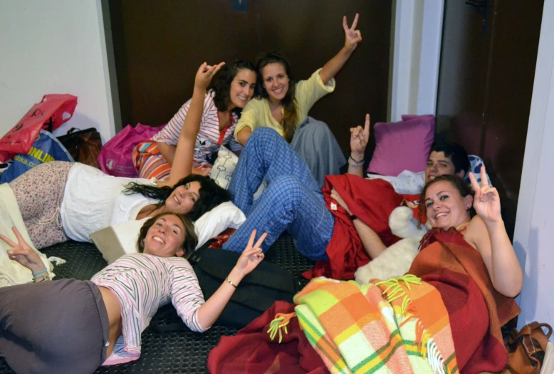 a group of girls posing on a bed