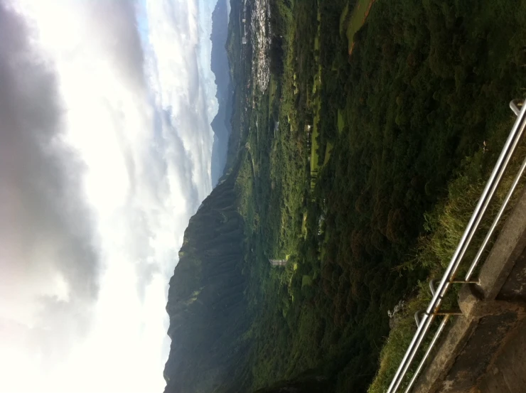 a person standing on the top of a mountain overlooking a valley